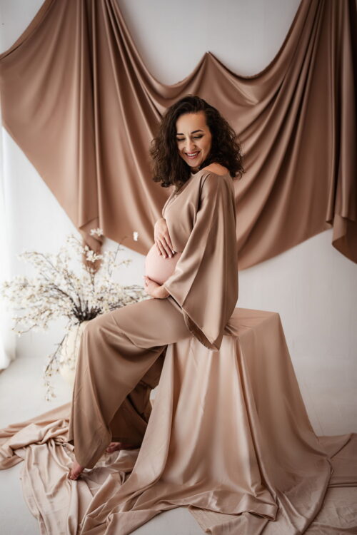 Pregnant woman wearing the latte satin Cecilia set