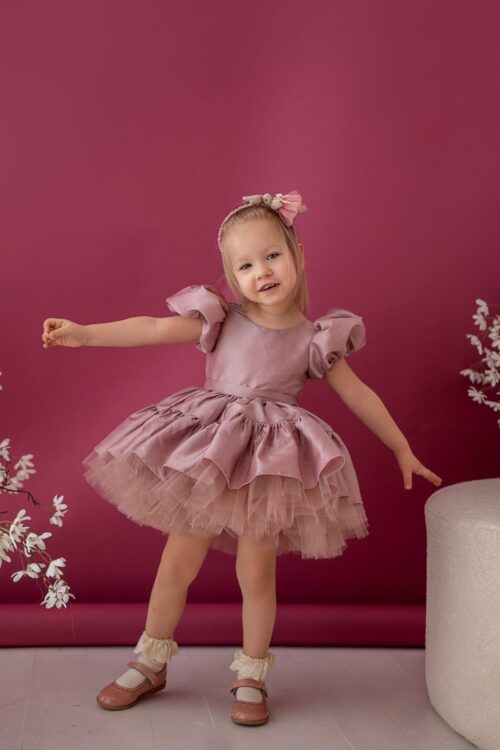 Girl in Rozalia dress with puff sleeves and layered tulle skirt, studio photo