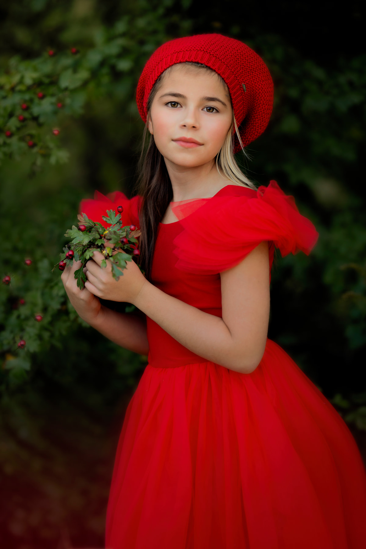 Girl wearing a tulle dress with a full skirt standing in a studio Christmas setup
