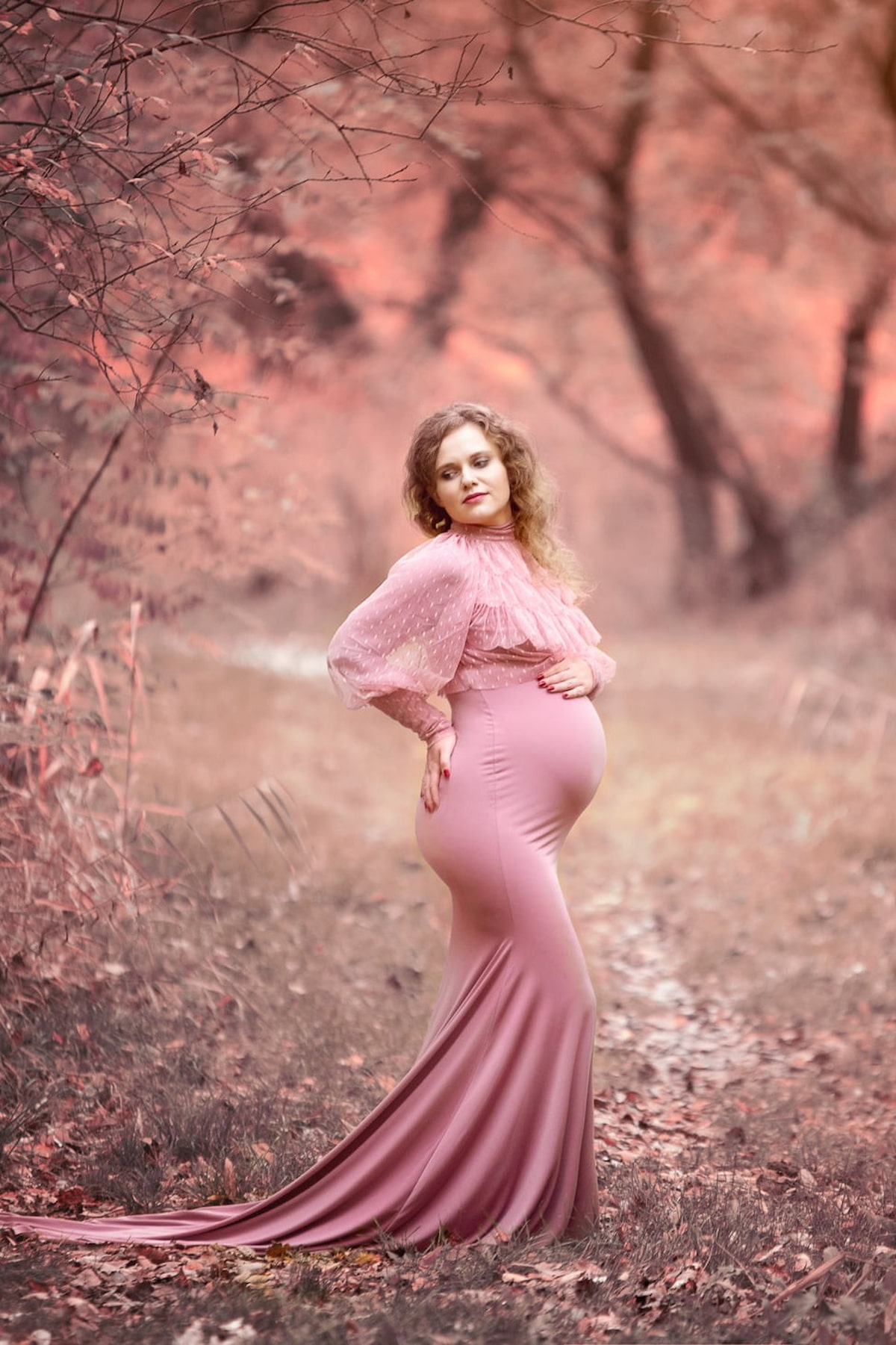 Maternity photoshoot outfit with sheer dotted tulle top and long fitted gown
